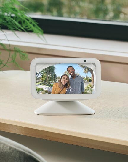 Two people appear smiling on the screen of an Amazon EchoShow.