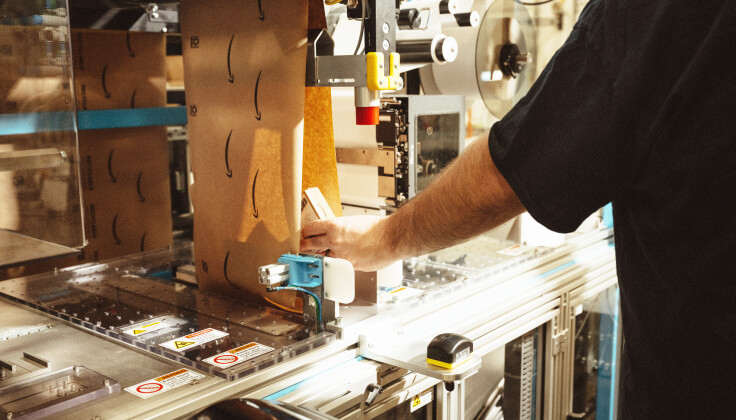 man working on a line with packaging